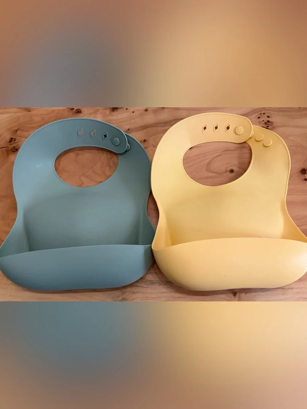Mushie Adjustable Silicone Bibs for Toddlers in Sage Green and Pale Yellow